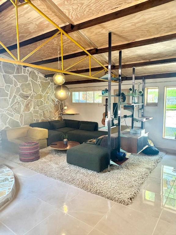 a living room with a green couch and a rug at Casacresta in Carabaño
