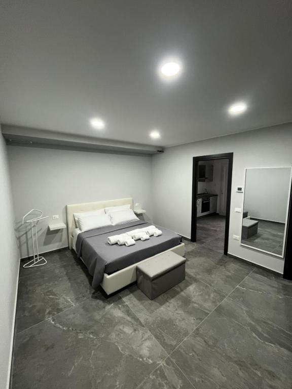 a bedroom with a large bed and a mirror at Dimora Deluxe in San Severo