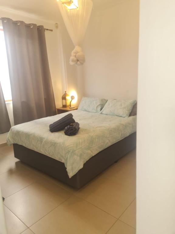 a bedroom with a bed with a robe on it at Comfortable Secure Business Stay in Johannesburg
