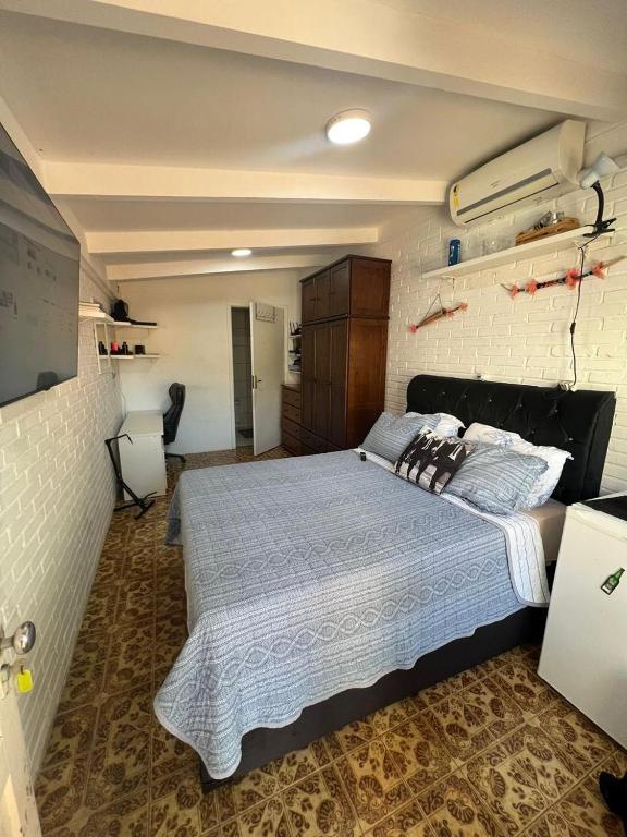 a bedroom with a large bed in a room at Suíte aconchego dos pássaros in Guaratuba