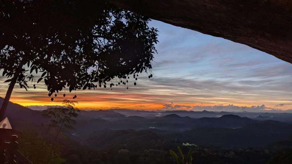 a view of a sunset from a tree at Serenity peak cottage Ella in Badulla