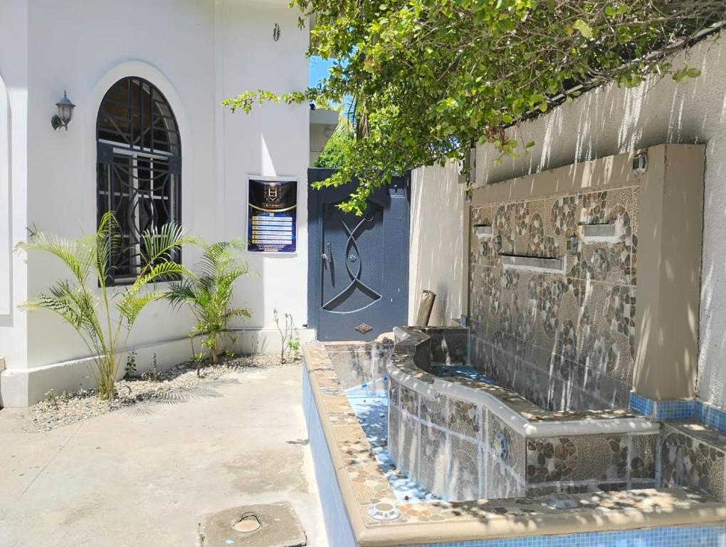 a water fountain outside of a building at Hotel El Elyon Ti Extra in Terrier Rouge