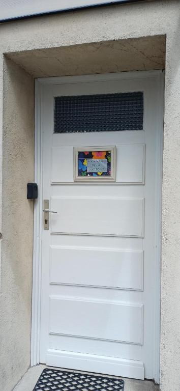 a white garage door with a picture on it at L escapade de la voie douce in Le Cheylard