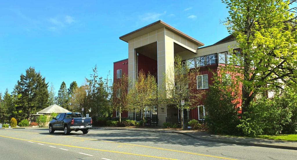 a truck parked in front of a red building at Cold Moon Inn in Nanaimo