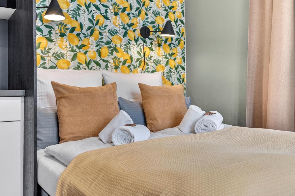 a bedroom with a large bed with pillows and a painting at Design Mini Studio No 9, Küche, Parkplatz, Wifi by BALANCED in Holzkirchen