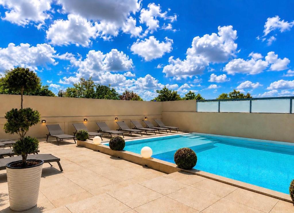 a swimming pool on top of a building at Alex Apartment Suites in Virós