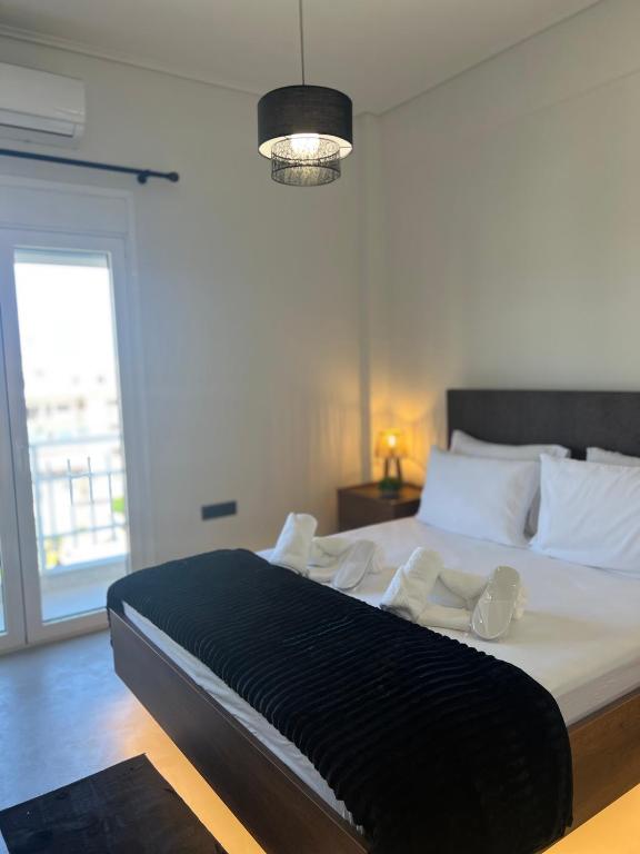 a bedroom with a large bed with white pillows at Urban Nest Corinth in Korinthos