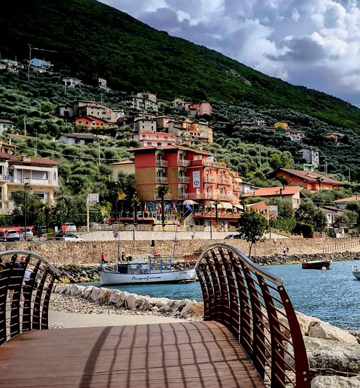 a bridge over a body of water with a town at Hotel Firenze 3 Stelle Superior in Brenzone sul Garda