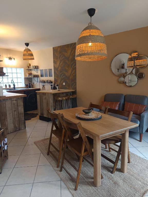 a kitchen and dining room with a wooden table and chairs at Casa del Castel in Dreux