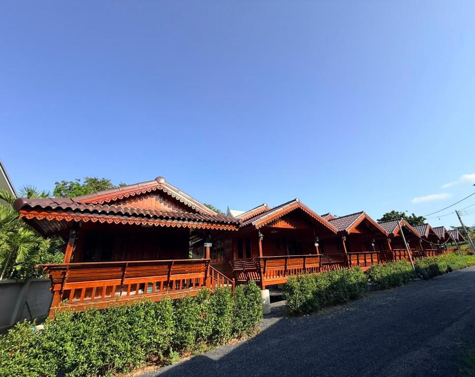 a row of wooden buildings on the side of a road at KT Thai House in Ban Ko Khwan