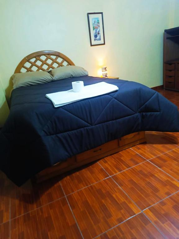 a blue bed with a tray on top of it at Shekina Huaraz Departament in Huaraz