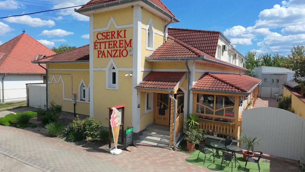 a building with a sign that reads czech kitchen pampa at Cserki Panzió Balatonfőkajár in Balatonfőkajár