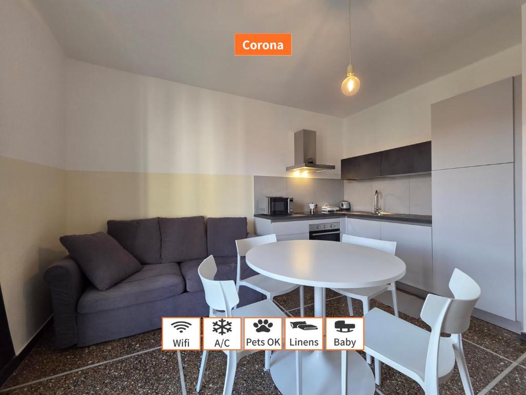 a living room with a couch and a table and chairs at Principe - By Turent in Pietra Ligure