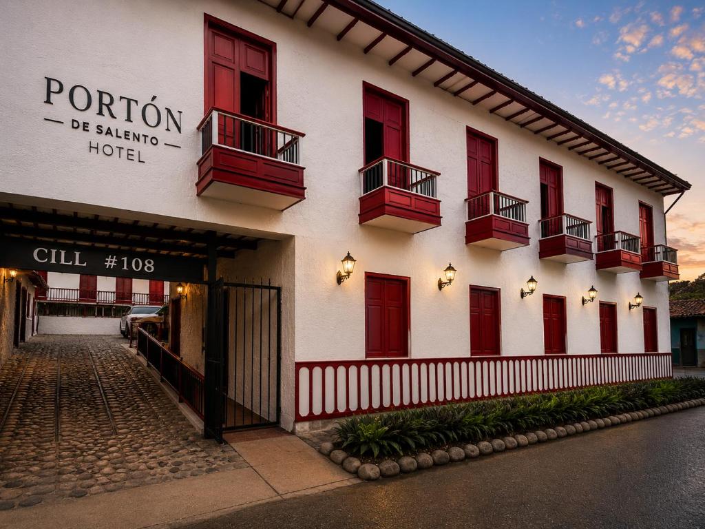 a building with red windows and balconies on it at El Portón de Salento in Salento