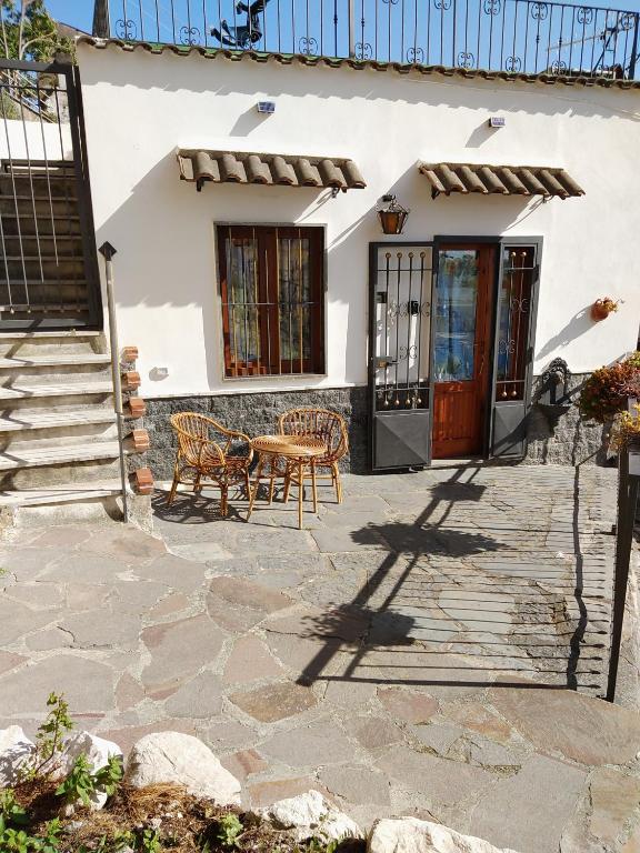 a house with two chairs and a table on a patio at House Le Antiche Mura in Castel Volturno