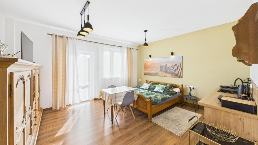 a living room with a couch and a table at Dębówka in Wilcze