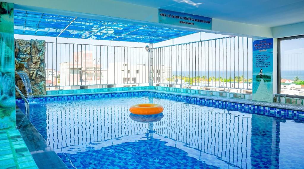 a swimming pool with an orange ball in the middle at Xanh Tốt Hotel - FLC Sầm Sơn in Sầm Sơn