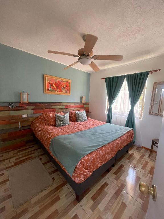 a bedroom with a bed with a ceiling fan at Rancho Elquino in Vicuña