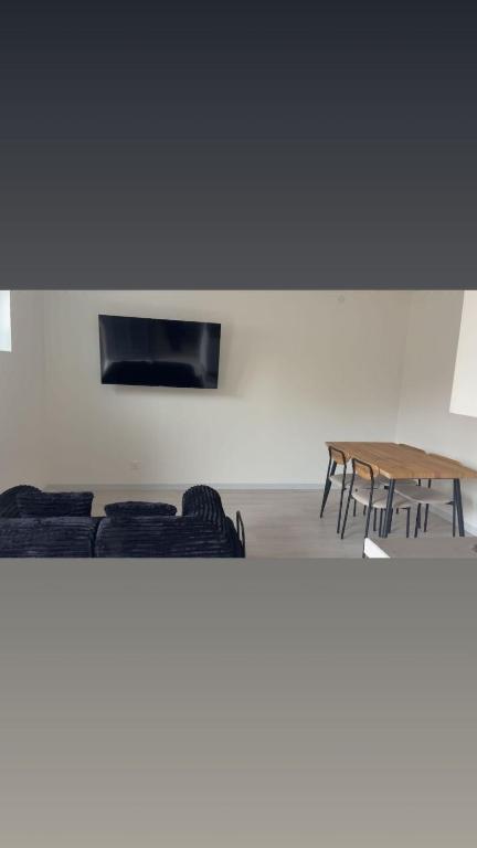 a room with chairs and a table and a wall at Apartment zoe in Erny-Saint-Julien