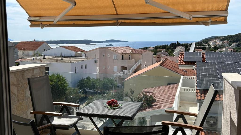 a balcony with a table and chairs and a view at HvarLove Seaview Luxury in Hvar