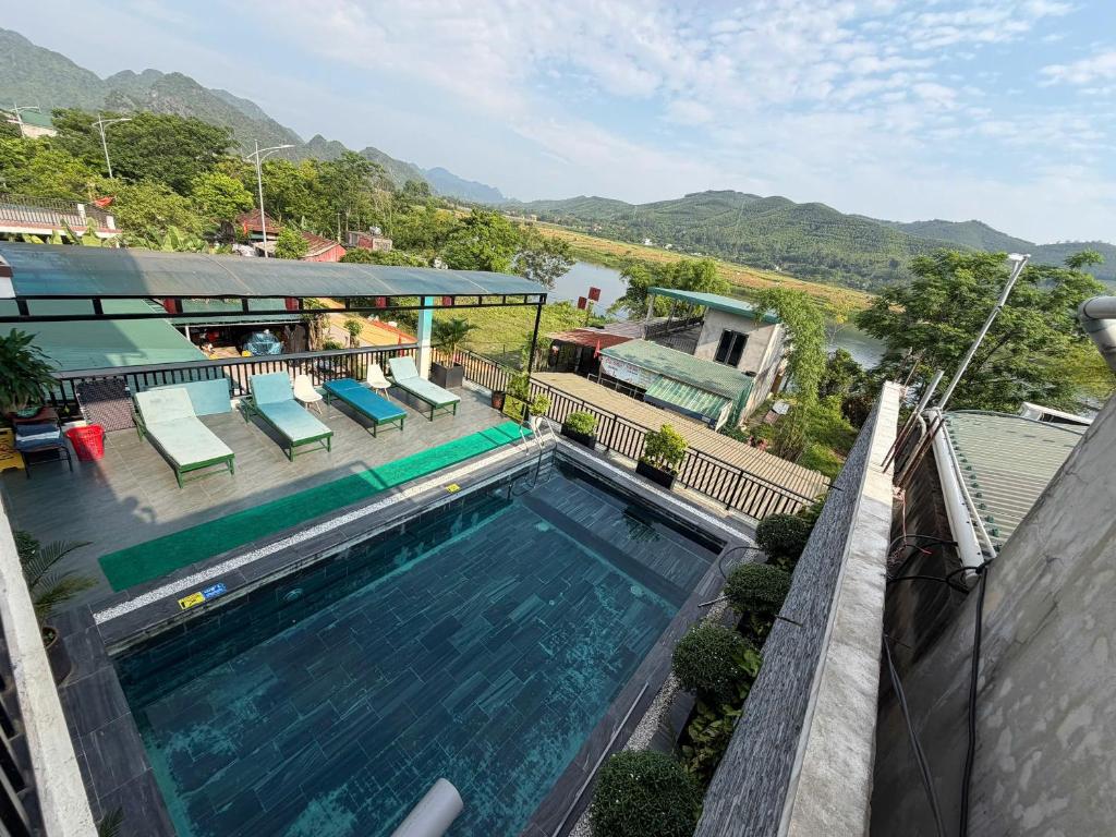 an overhead view of a swimming pool with mountains in the background at Phong Nha TuTu's House in Phong Nha