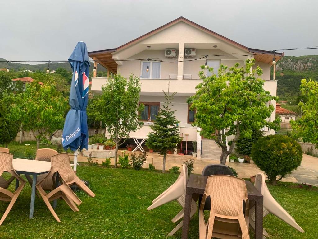 a group of chairs and a table and an umbrella at Villa Rejan in Pogradec