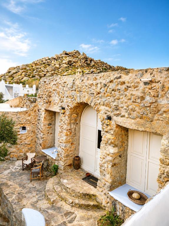 a stone building with two garage doors on it at Artemis Cottage Authentic Mykonian Stone House near Super Paradise in Super Paradise Beach