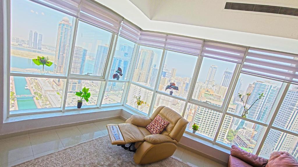 a living room with a large window view of a city at Luxury Skyline Apartment with Panoramic Views in Sharjah