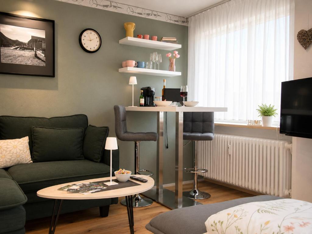 a living room with a couch and a table at Haus Madeleine in Schönwald