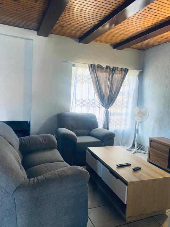 a living room with a couch and a coffee table at Number 8 in Maseru