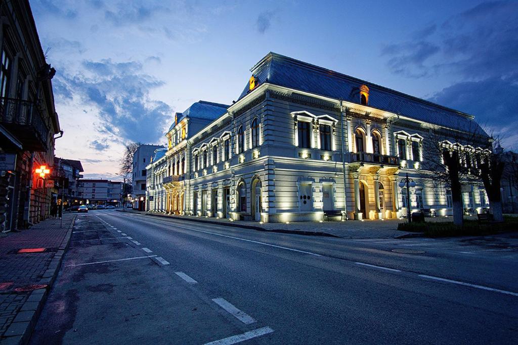 a large white building on the side of a street at Buchenland Hotel in Câmpulung Moldovenesc