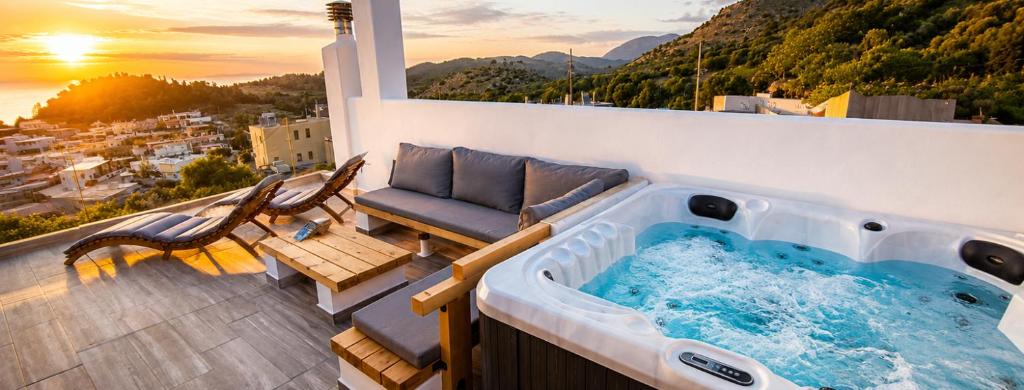 a hot tub on a balcony with a view of a city at Rustic House Smaro Embonas - Jacuzzi Experience in Émbonas