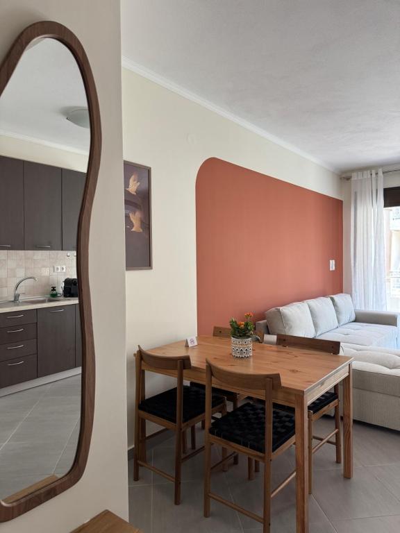 a living room with a table and a mirror at SnappyB Living Spaces in Alexandroupoli