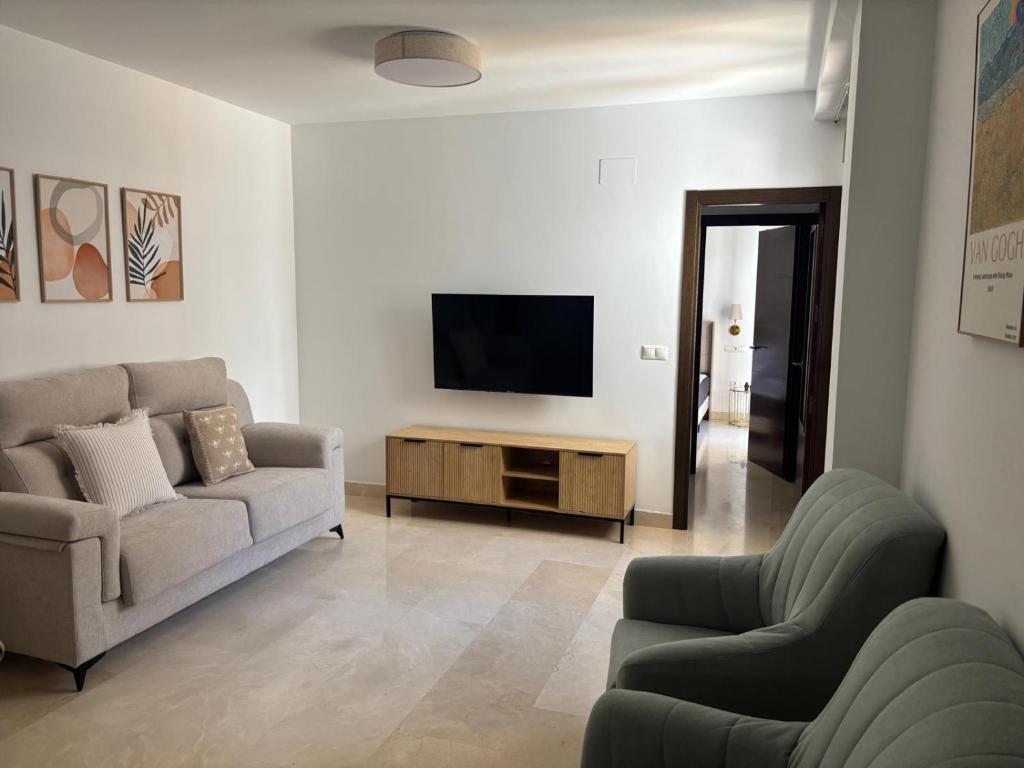 a living room with a couch and a tv at Fuente De La Salud in Priego de Córdoba