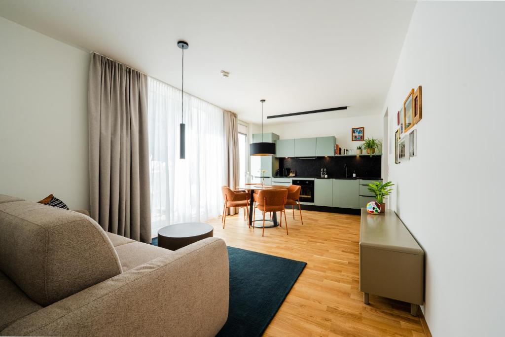 a living room with a couch and a table at Noas Bergisel in Innsbruck