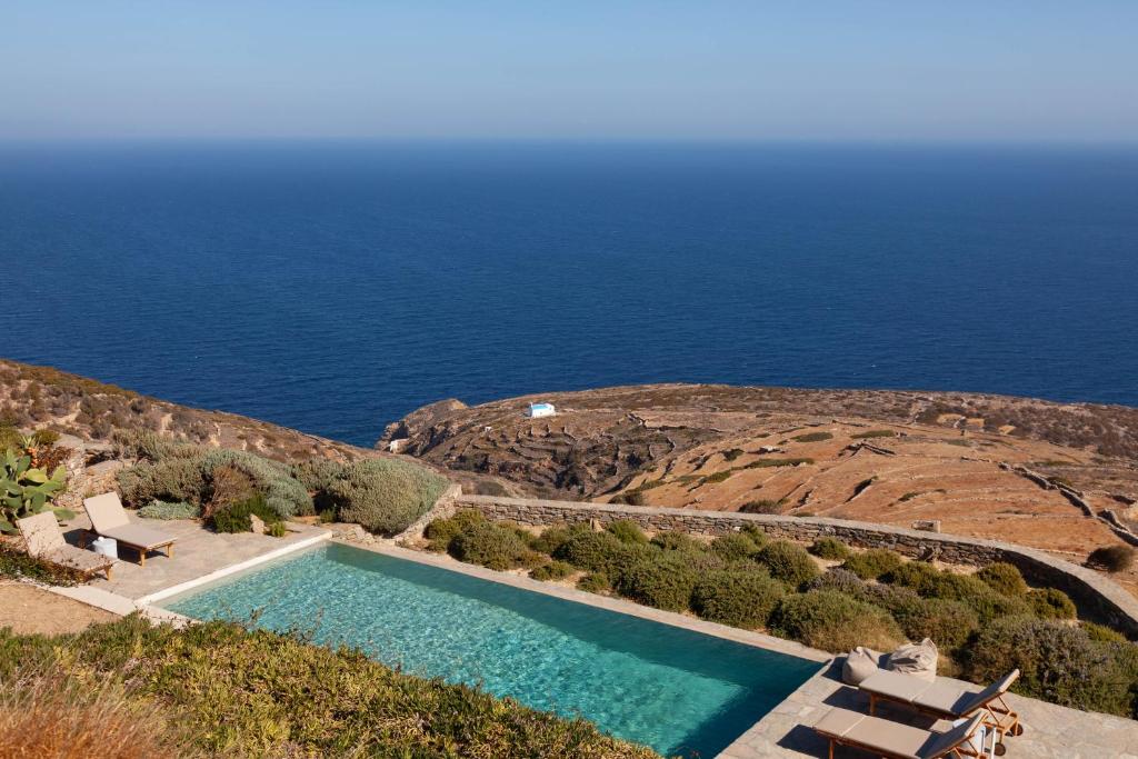 a swimming pool with the ocean in the background at Astarte Sifnos in Artemonas