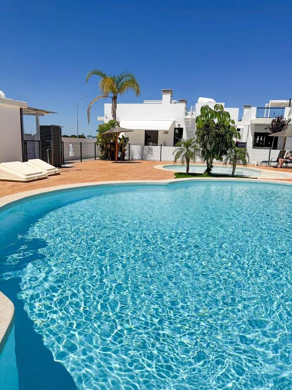 a large blue swimming pool in front of a house at Luxury Costa Blanca Villa near Denia with pool and roof terrace in El Verger