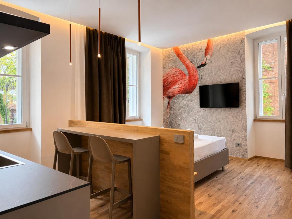 a room with a bed and a kitchen with a bar at Luxury Lodge - Moderno Residence vicino alla Stazione in Trieste