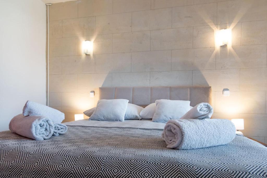 a bedroom with a large bed with towels on it at Apartments Gurman in Rab