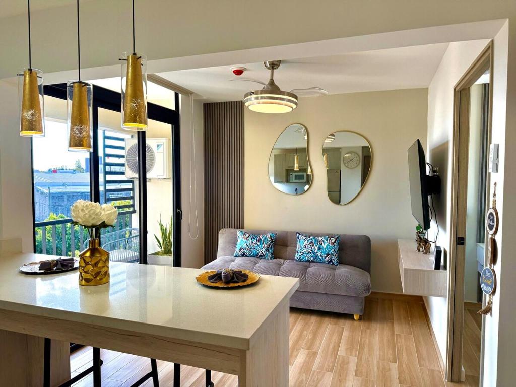 a living room with a couch and a table at Panoramic view apartment with Pool and Rooftop in San Salvador