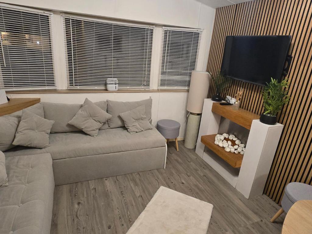 a living room with a couch and a flat screen tv at D&D Getaways in Hull