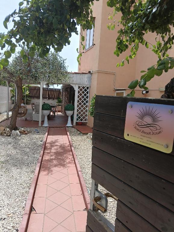 a house with a sign on the side of a fence at Karol Beach House in Santa Marinella
