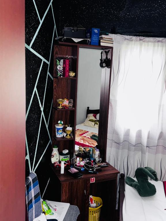 a bedroom with a mirror and a bed at The peace place in Ella