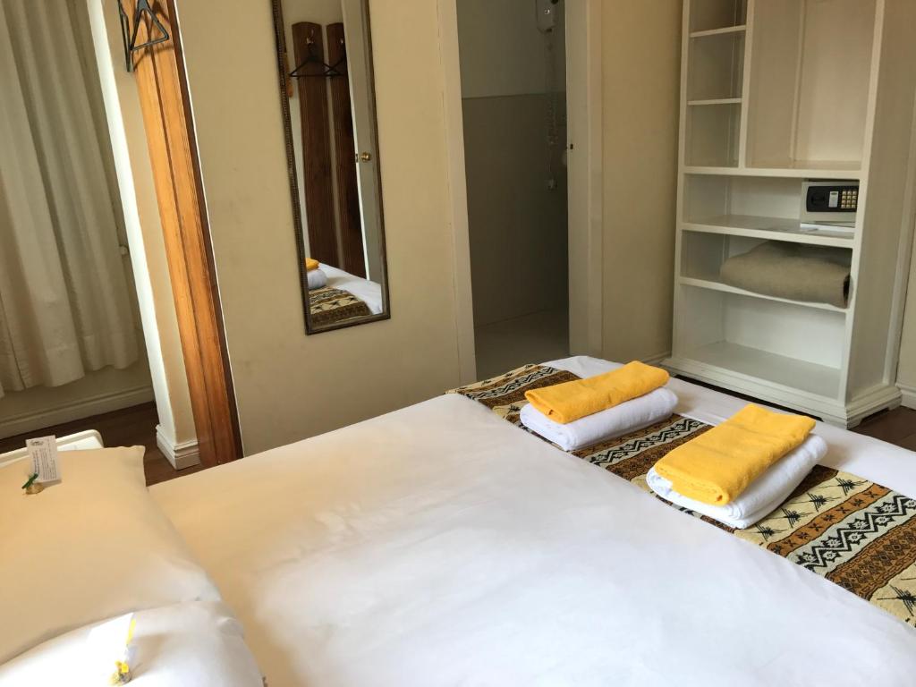 Postel nebo postele na pokoji v ubytování Hotel Cayman