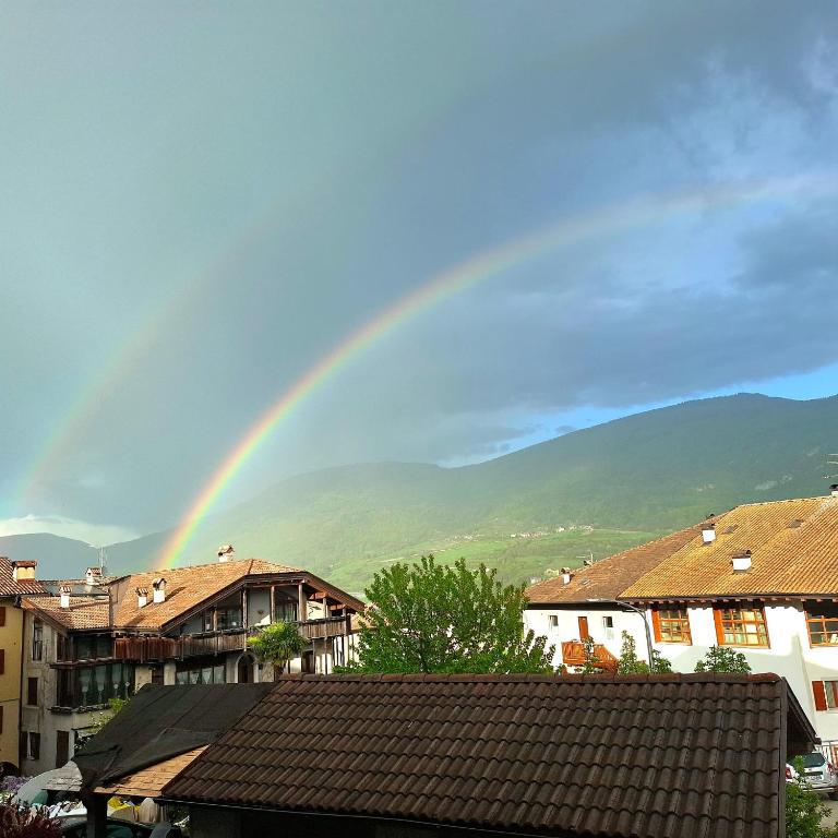 a rainbow in the sky over a city at Casa Ewa in Fiavè