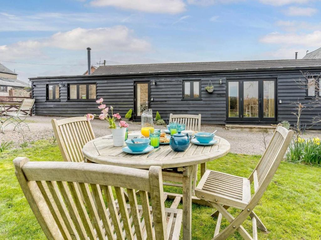 a wooden table in the backyard of a house at 2 Bed in Usk- oc-87285 in Llandenny