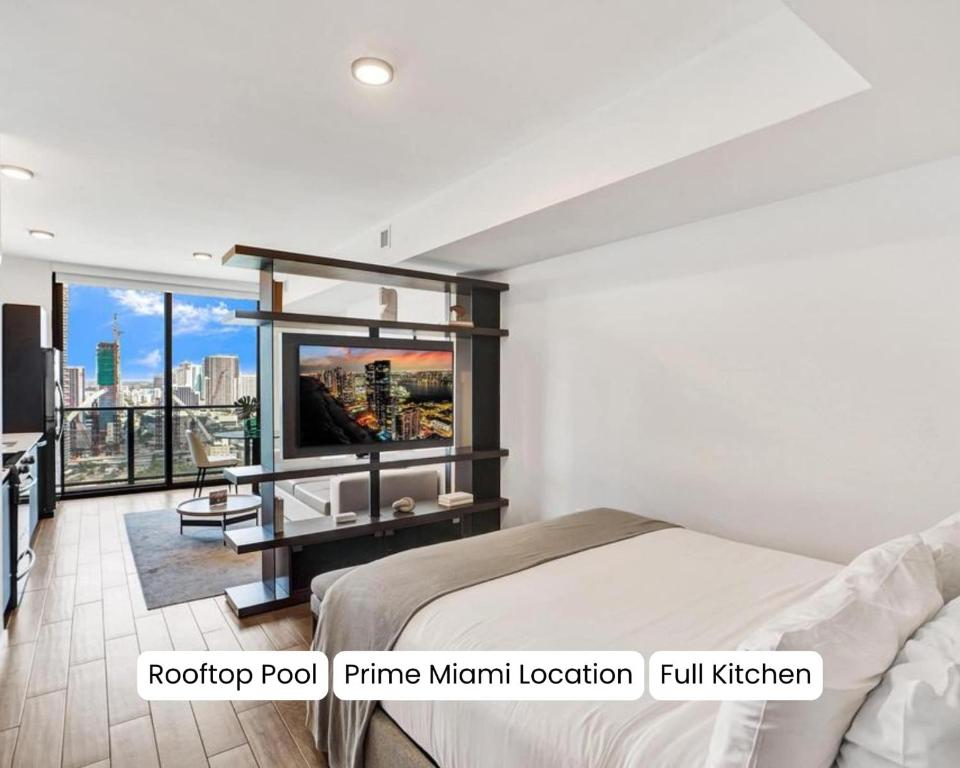 a bedroom with a bed and a tv on a wall at Luxury Miami Studio 27th Floor in Miami