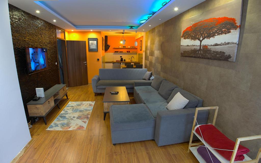 a living room with a couch and a table at Prishtina Host in Prishtinë