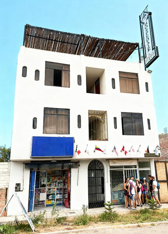 a group of people standing in front of a building at Hospedaje El Encanto del Bosque in Ica