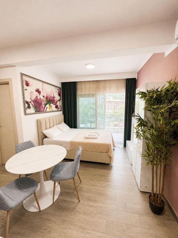 a hotel room with a bed and a table and chairs at Blue Bay Studio in Bečići